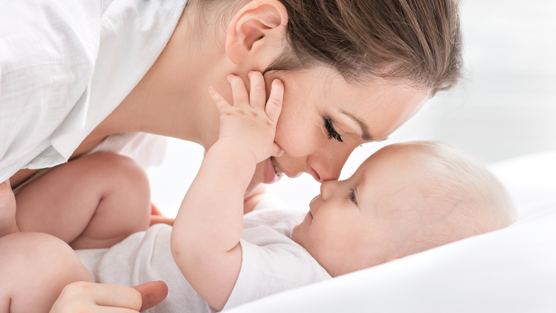 mom starring at baby on bed