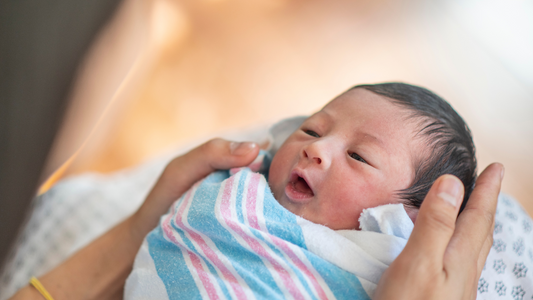 newborn baby on mom's lap