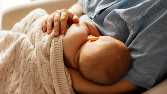 mom breastfeeding baby on the couch